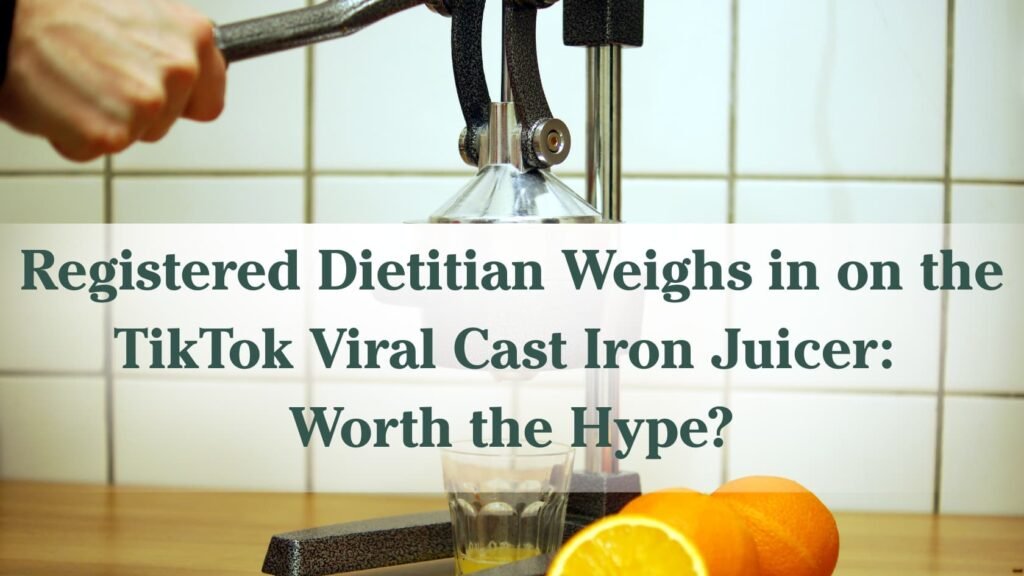 "Registered Dietitian Weighs in on the TikTok Viral Cast Iron Juicer: Worth the Hype?" with a background of an arm pressing a orange in a cast iron juicer with some oranges sitting next to it.